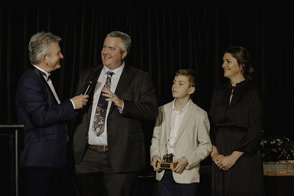 Steve Davis interviews Fraser Auret alongside his son Milton and wife Erin at the National Breeding Awards on Saturday Photo: Christine Cornege