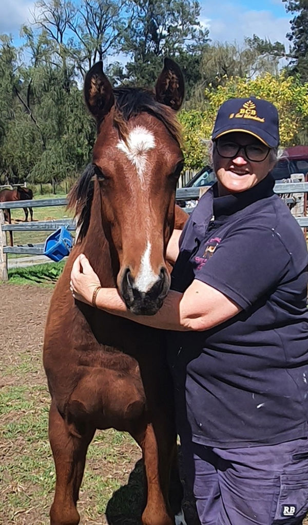 Rachael Bryce with a weanling filly by Tassort.