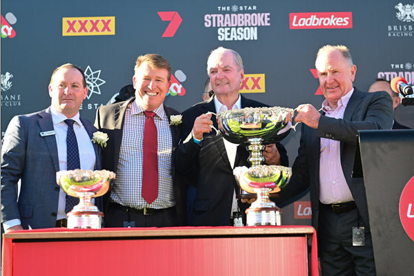  Owners Neville Morgan (right) and David Devine (second from right) celebrate Kovalica’s Derby triumph Photo: Grant Peters (Trackside Photography)