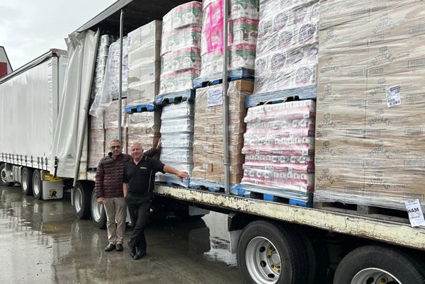 Roger James and Tony Rider pictured beside a cyclone relief bound truck.