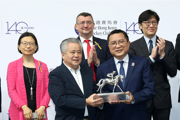 Owner Tung Moon Fai collects the trophy for Champion Griffin - image HKJC