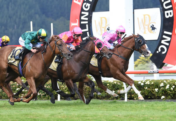 A beaming Lisa Allpress guides Grand Mayson (inner) to victory in the Listed Hardy Trade Supply Company Lightning Handicap (1200m). Photo Credit: Race Images – Peter Rubery
