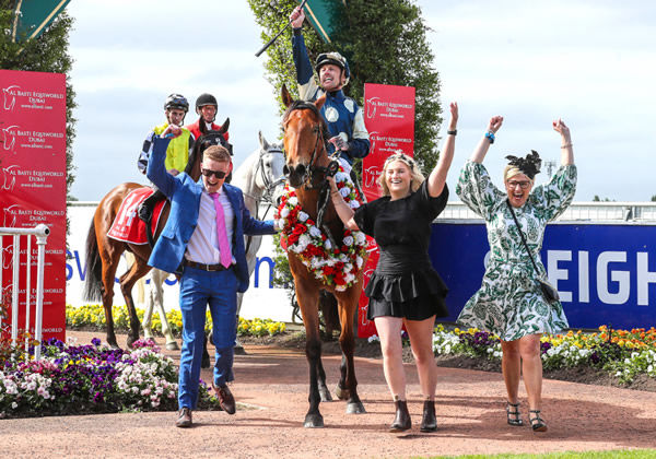 A jubilant Michael McNab shares the joy of a Group One win with members of the Weatherley family (L-R Sam, Briar and Lou) as they bring Pier back to the Riccarton birdcage Photo: Race Images South
