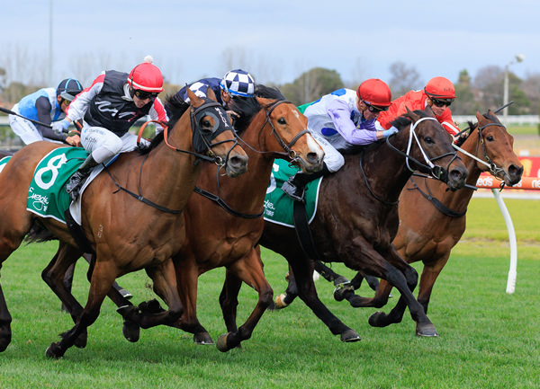 Savannah Cloud (red cap) wins the Listed Regal Roller Stakes - image Grant Courtney